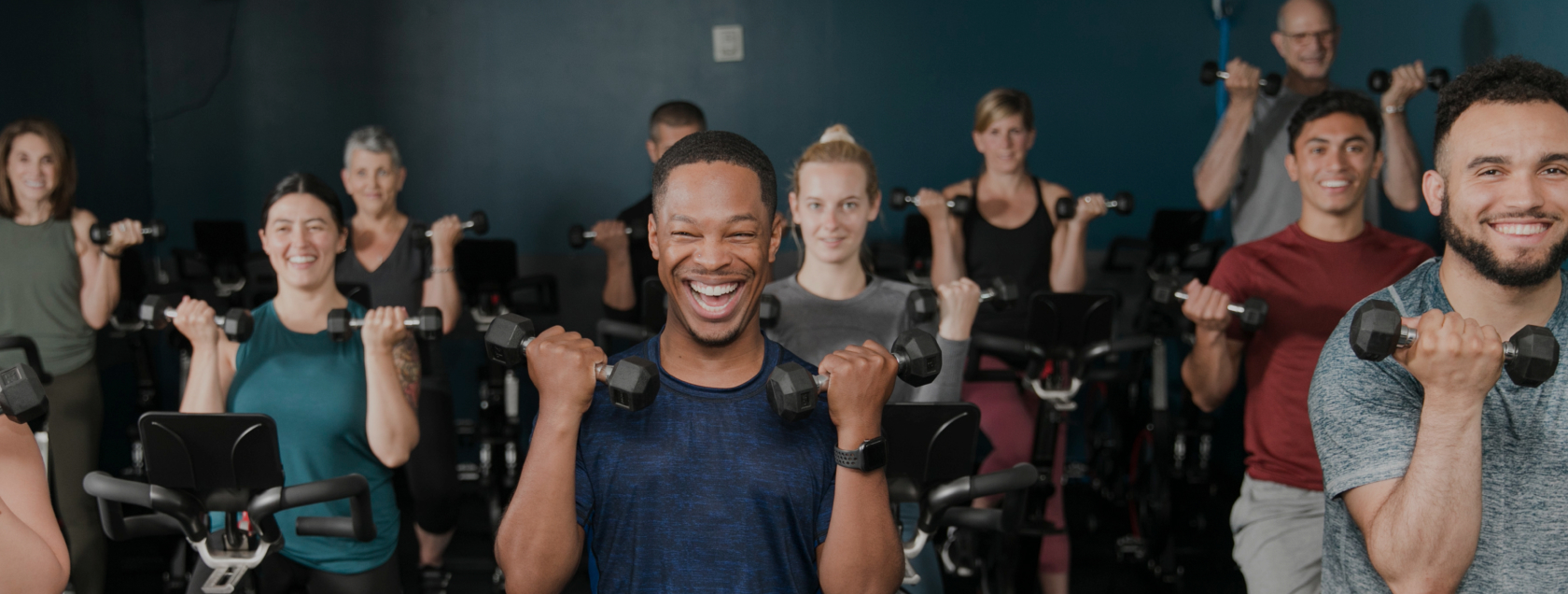 group fitness class using dumbbells