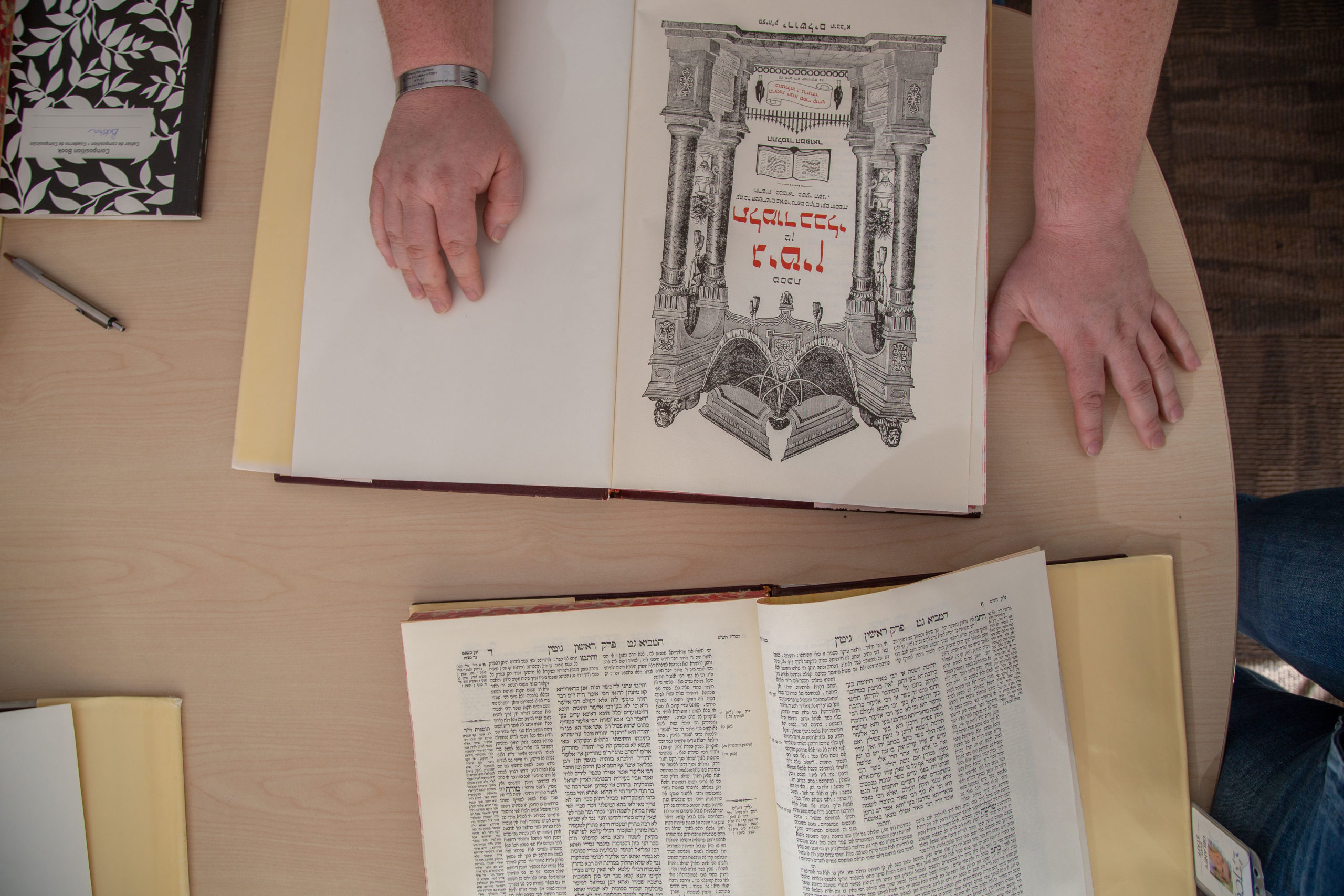 Photo of book with hands resting on it