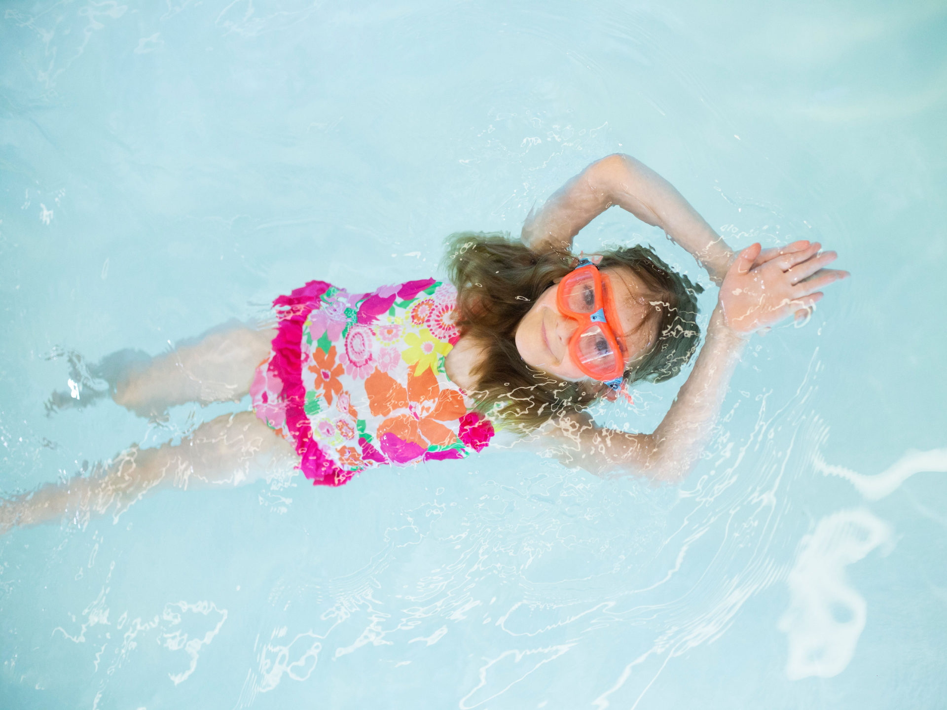 Young girl swim on her back