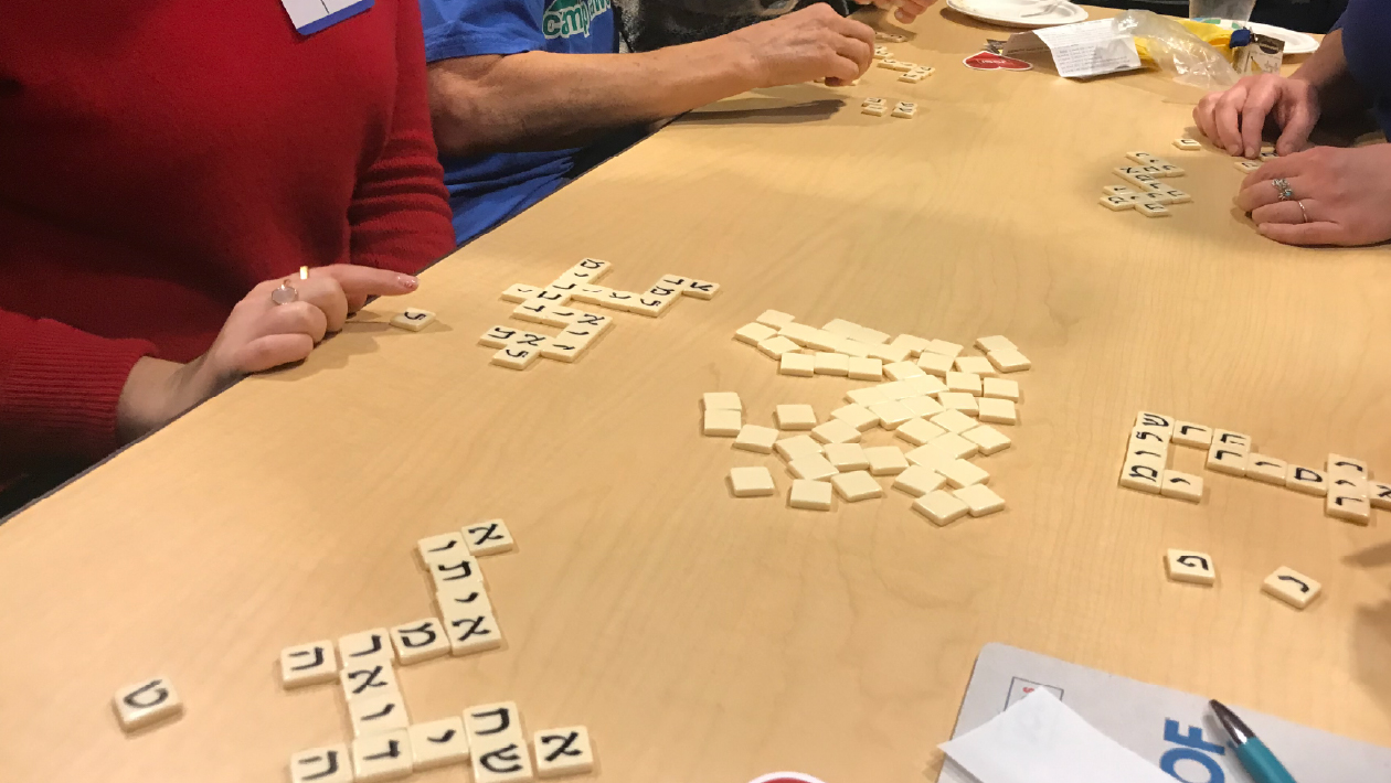 Students playing a game with Hebrew tiles (somewhat like Scrabble).