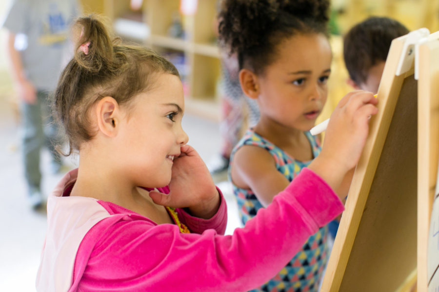 Girls painting at Brotherhood Way Preschool.