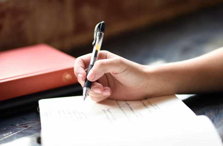 woman writing in journal