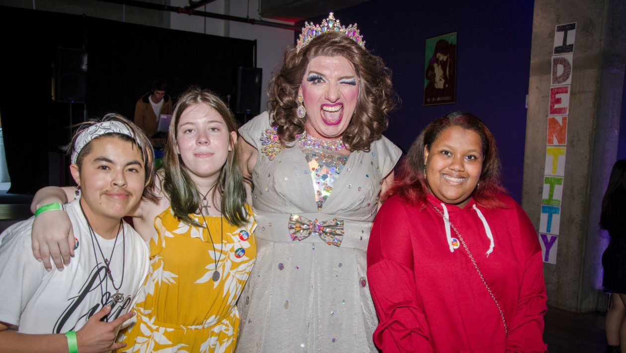 Group of teens pose with drag queen