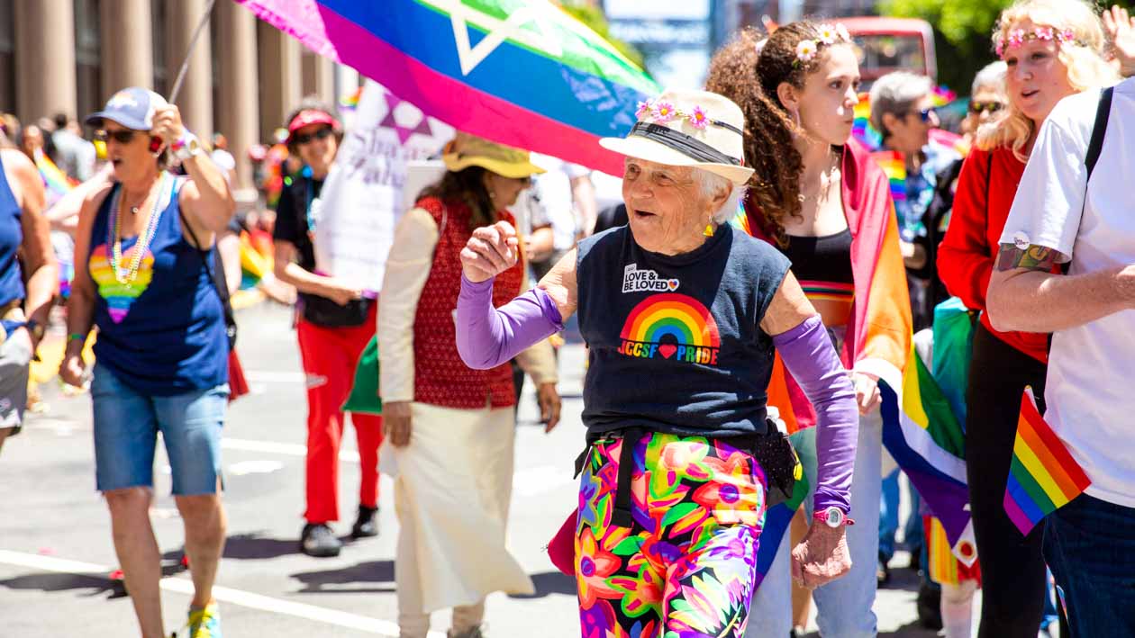 Elderly woman walks in Pride parade