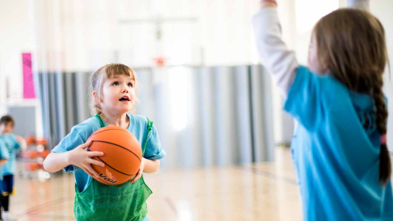 Girl shoots basketball during youth practice