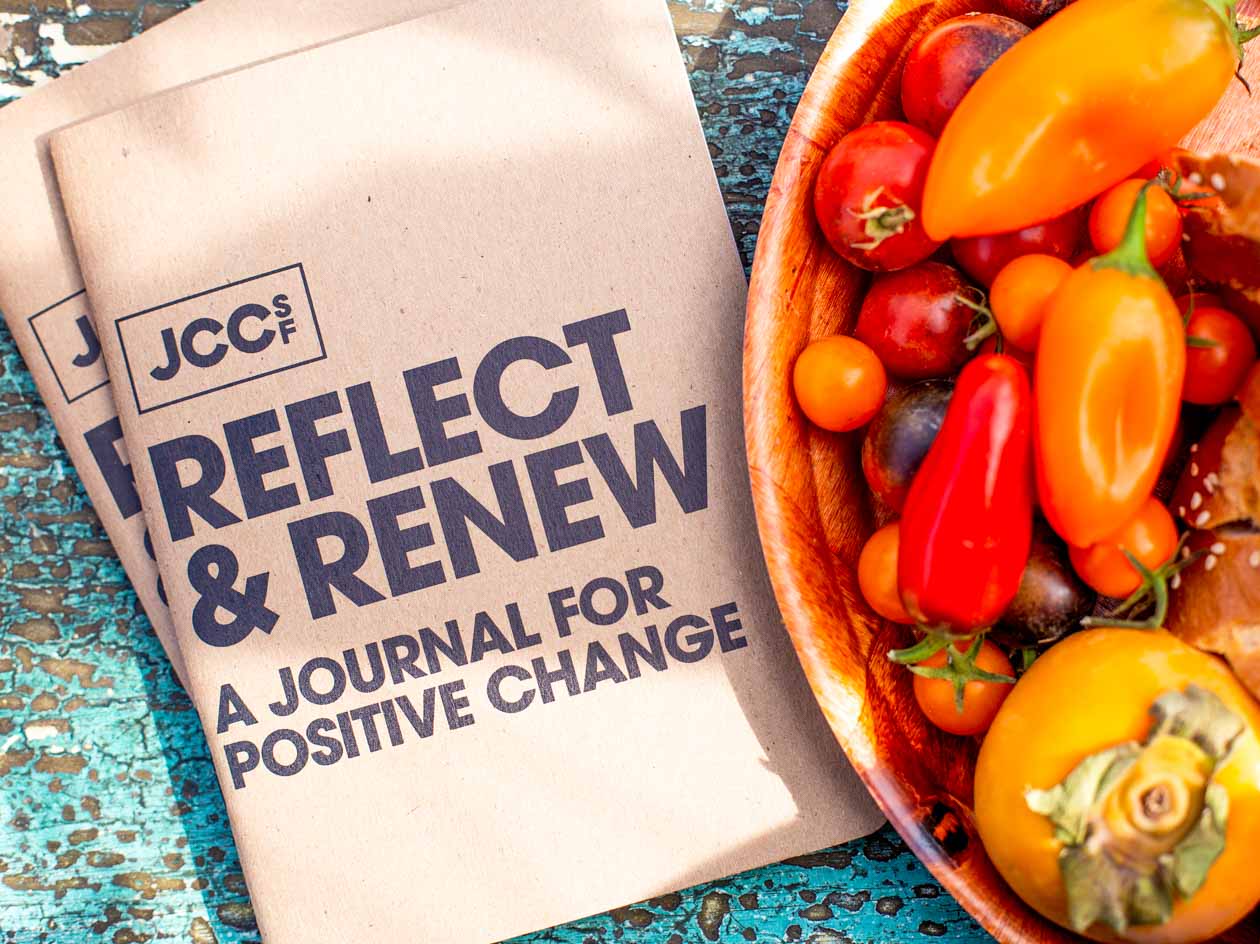 JCCSF pamphlet sits beside bowl of vegetables