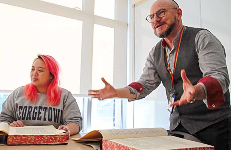 Jewish man teaches from large book