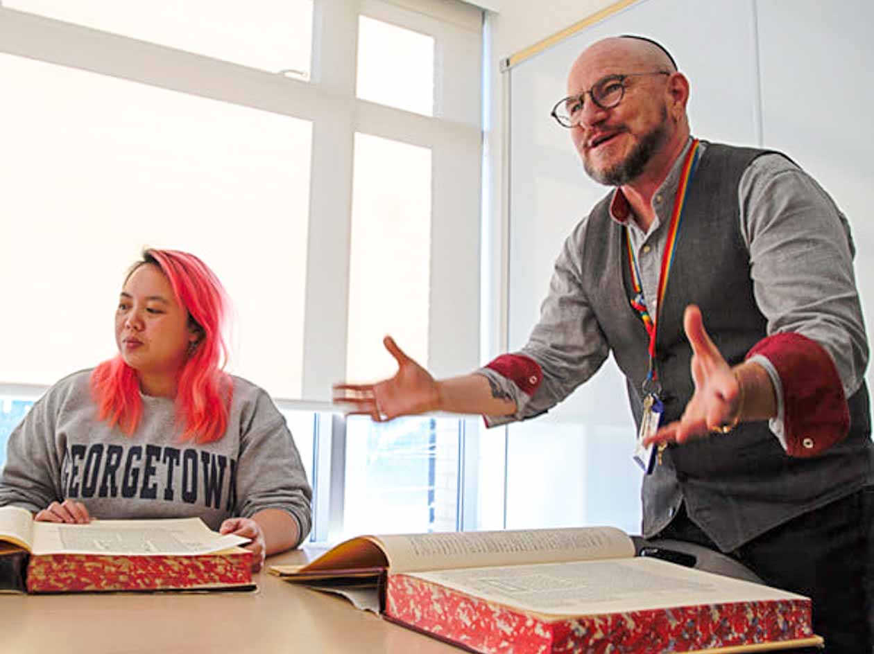 Jewish man teaches from large book