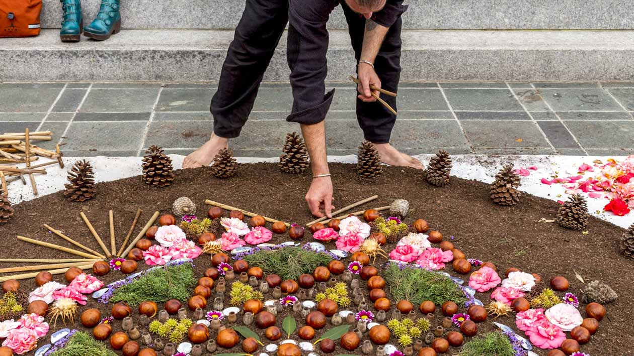 Person arranges flowerbed pattern