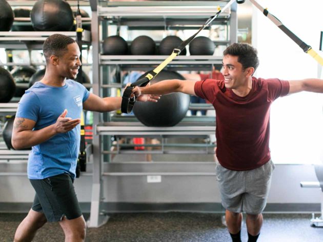 Personal trainer helps with resistance training