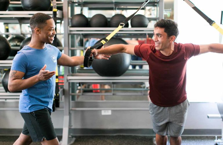 Personal trainer helps with resistance training