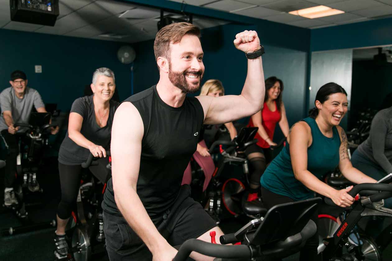 Man fist pumps during spin class