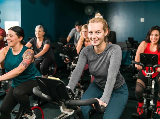 Smiling woman in spin class