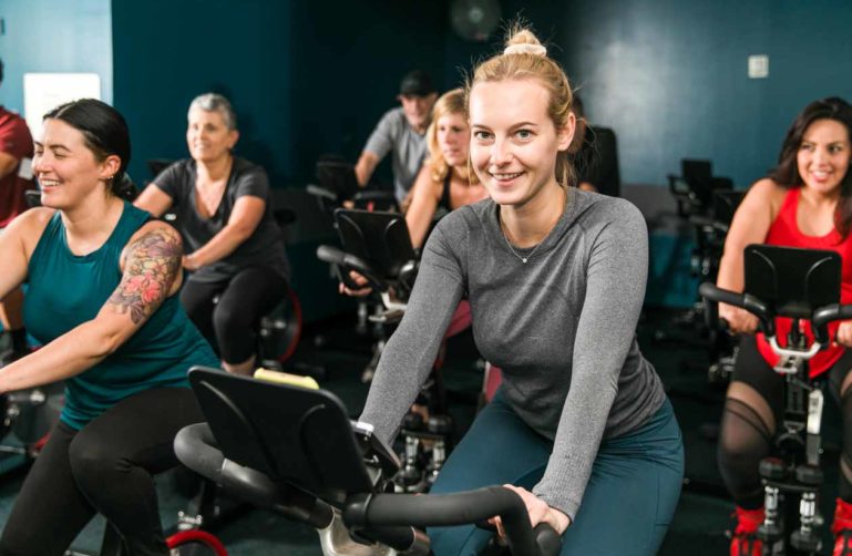 Smiling woman in spin class