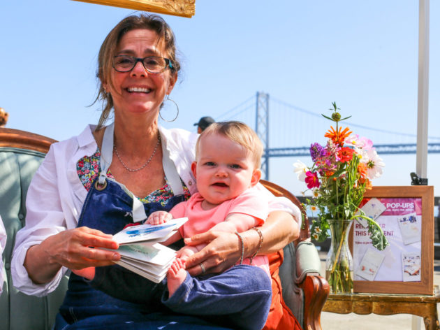 Woman holds baby in lap at Sukkot popup