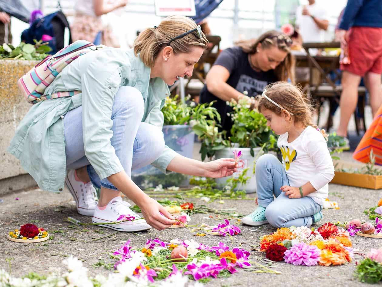 Woman and child make bouquets at JCCSF popup