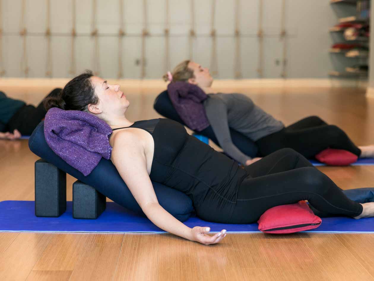 Yoga class does relaxation pose