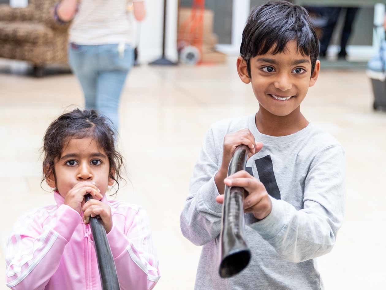 Young children play wooden flutes at JCCSF gathering