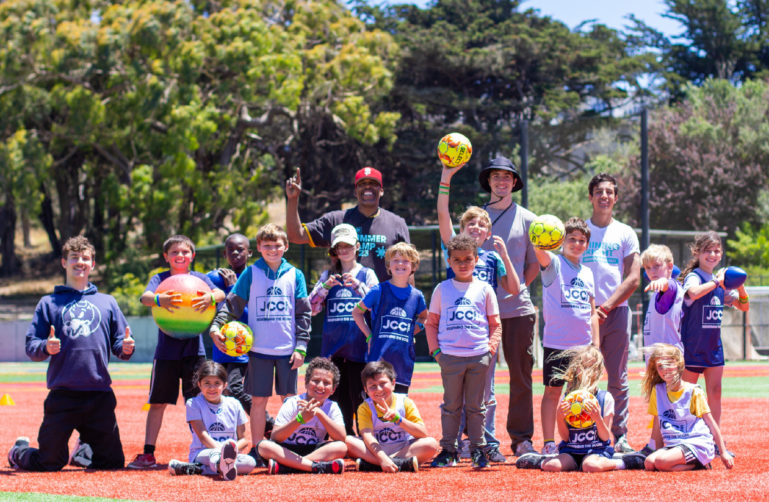 JCCSF Summer Camp kids on the soccer field in the sunshine.