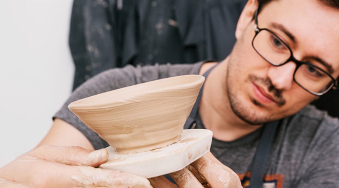 man looking at clay pot