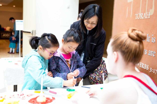 Young girls try potato stamps at Family Festival