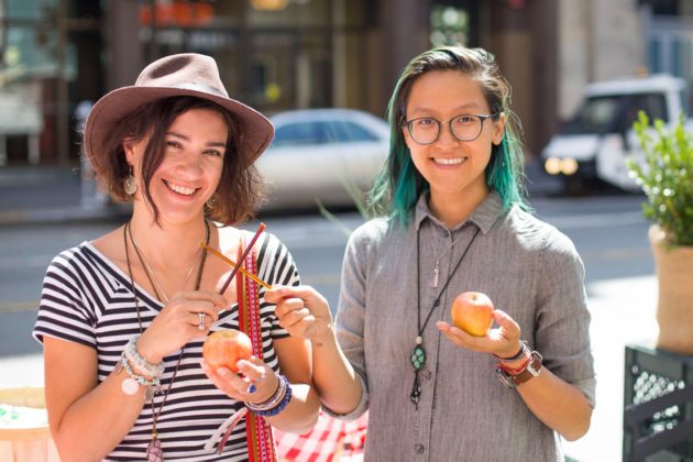 Two people holding apples