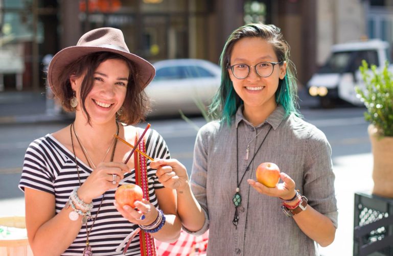 Two people holding apples