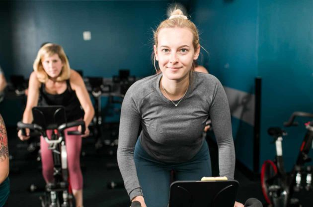 Smiling woman participates in spin class
