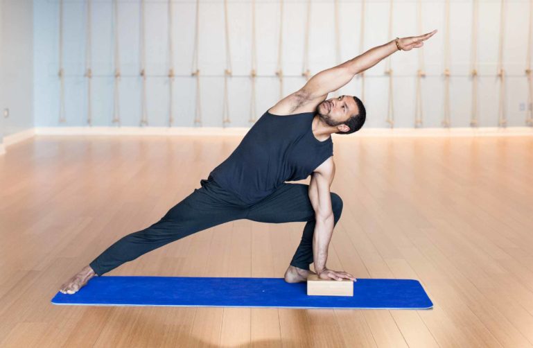 Man stretches in yoga pose