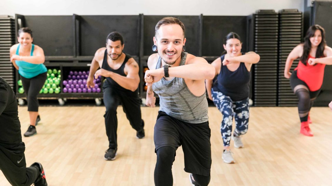 Zumba class lunges during dance