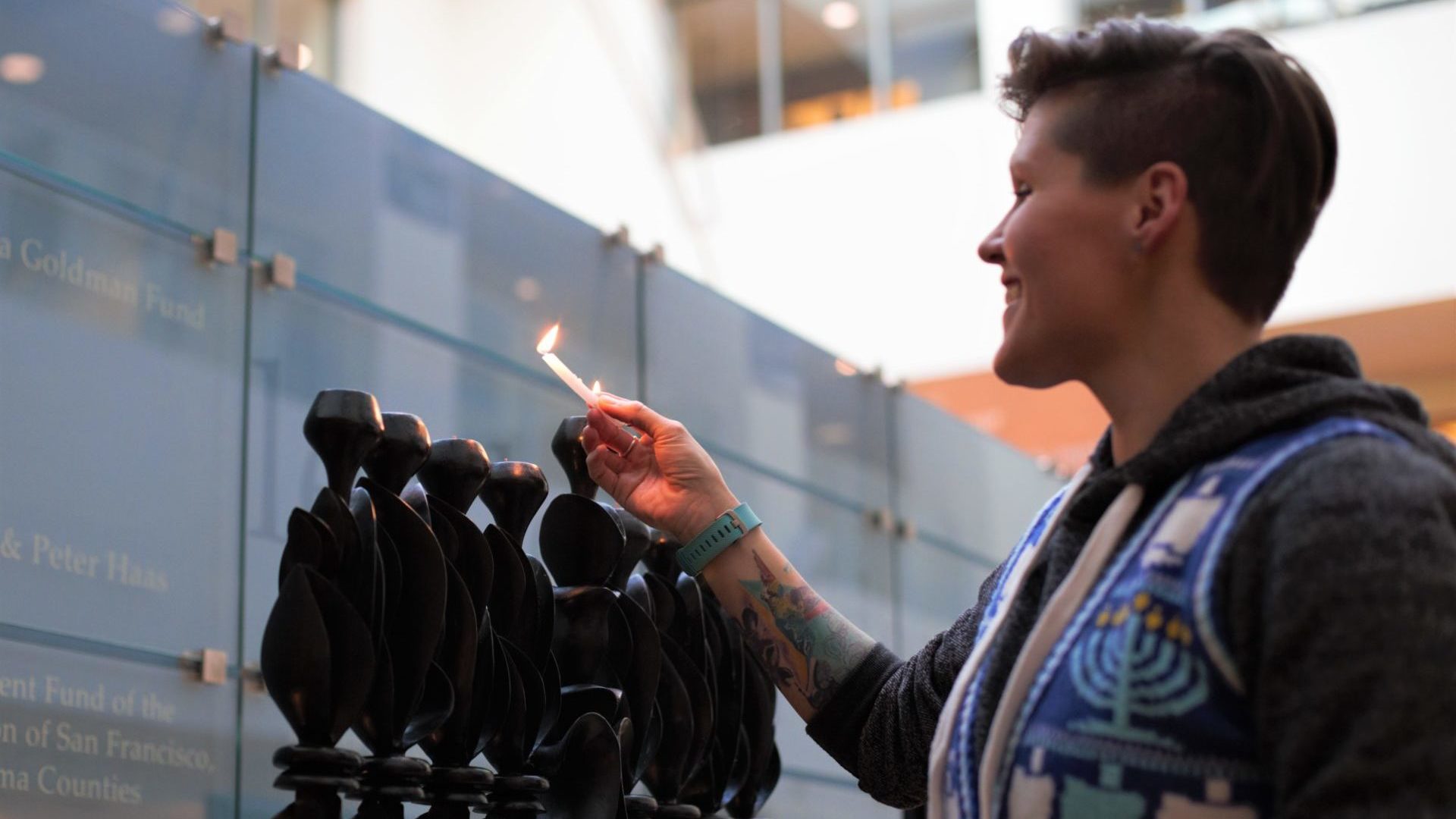 Person lights the hanukkiyah