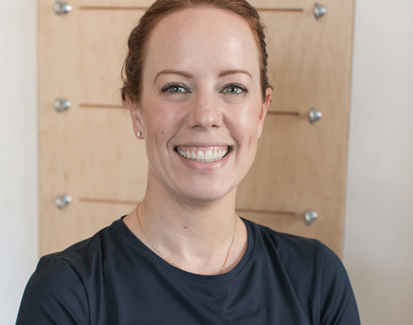 woman smiling wide with dark hair and black shirt