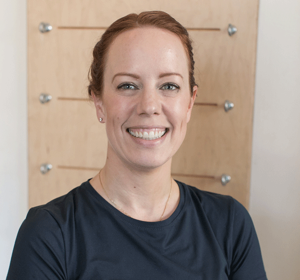 woman smiling wide with dark hair and black shirt