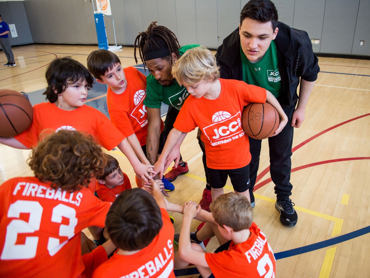 Basketball players and coaches in a huddle