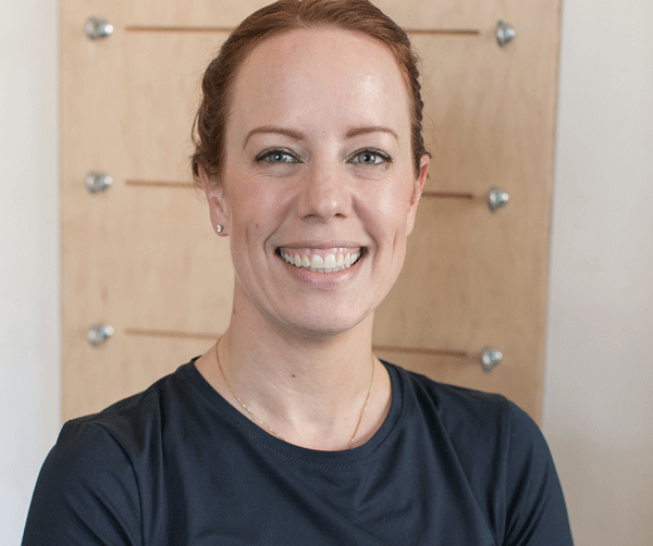 woman smiling wide with dark hair and black shirt