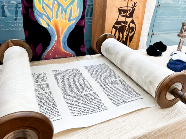 The Torah opened on a table to be read.