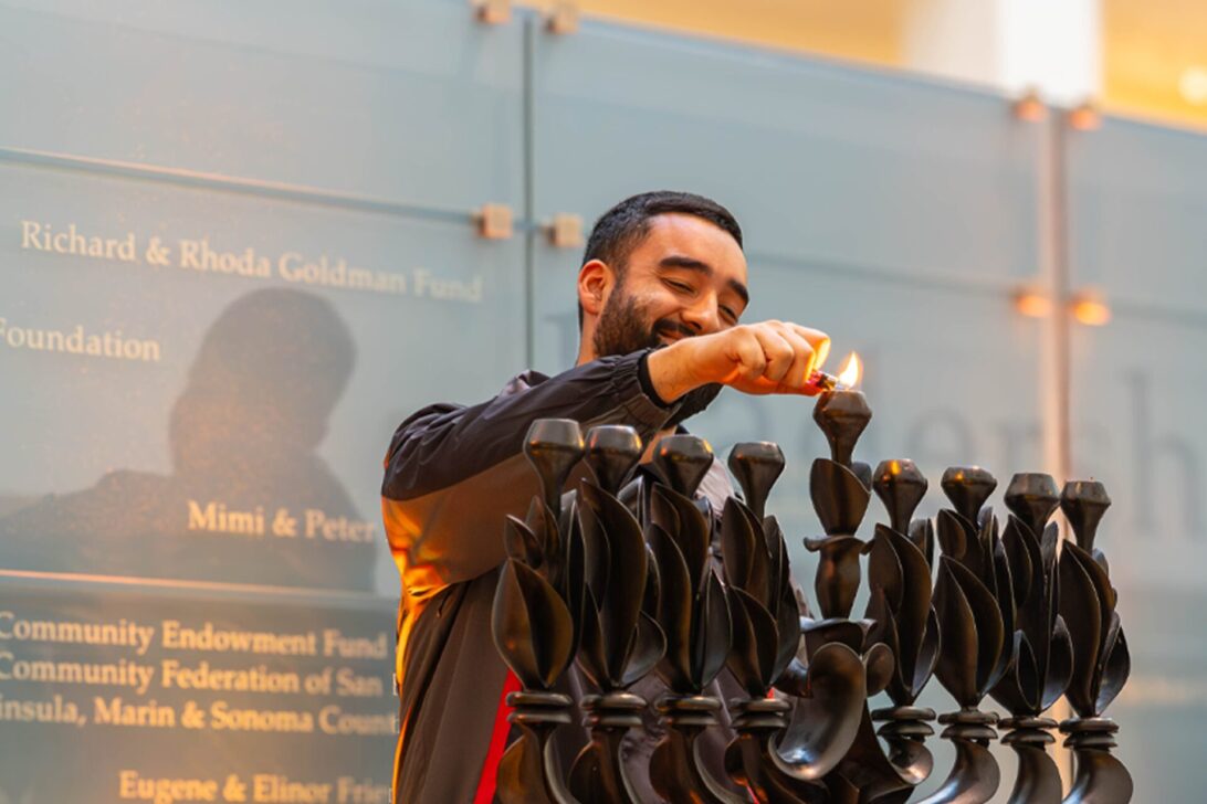 Security guard lighting the menorah